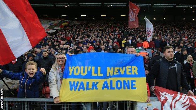 A banner on the Kop in the colours of the flag of Ukraine during the Premier League match between Liverpool and West Ham United