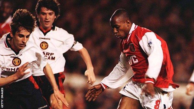 Ian Wright (right) in action against Manchester United in 1997