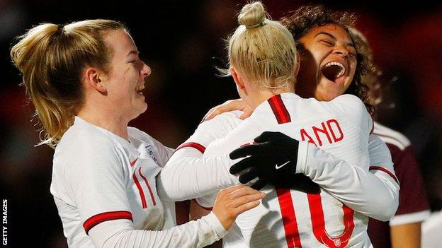 Jess Carter is congratulated by England team-mates after scoring in the win over Latvia