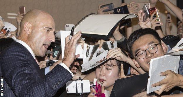 Strong poses for fans at the photocall for Kingsman: The Golden Circle in Seoul, South Korea