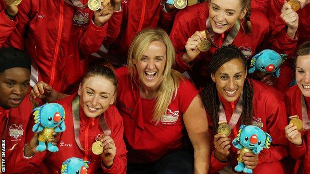 Tracey Neville celebrates Commonwealth gold with some of the England netball team