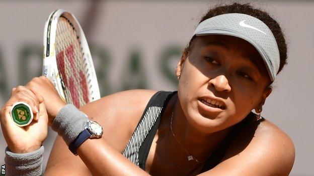 Naomi Osaka returns a ball at the French Open