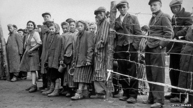 April 1945: Starving internees at Bergen-Belsen concentration camp waiting at the cook house gate for their rations of potato soup