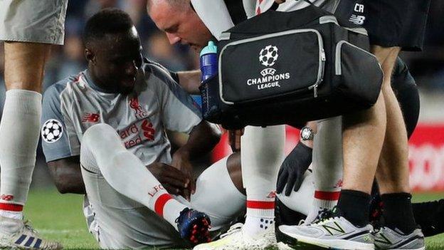 Liverpool midfielder Naby Keita receives treatment during the Champions League defeat at Barcelona