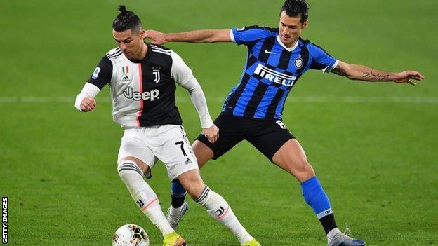 Cristiano Ronaldo of Juventus and Antonio Candreva of Inter Milan challenge for the ball