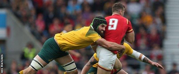 Australia's Scott Fardy tackles Wales scrum-half Gareth Davies