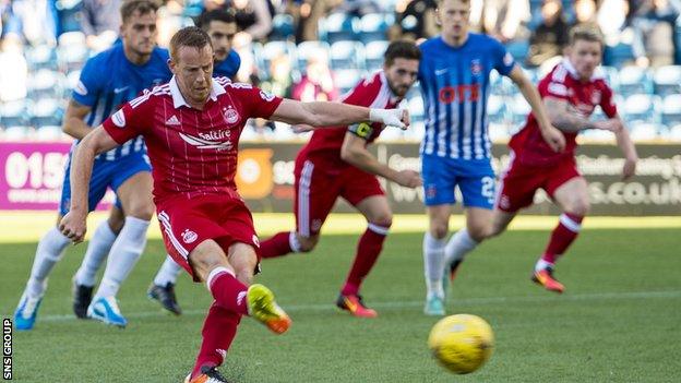 Adam Rooney sweeps the ball home from a controversial penalty award