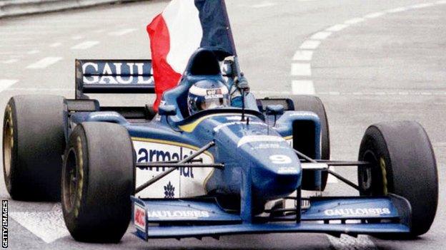 Olivier Panis waves a French flag while in the Ligier car after winning the Monaco GP in 1996