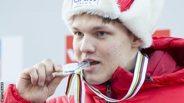 Roman Repilov bites his silver medal at the 2017 World Luge Championships