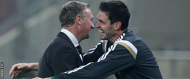 Michael O'Neill embraces Kyle Lafferty after Northern Ireland's qualifier win in Greece