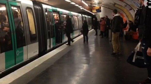 Image of a man being pushed off the Metro in Paris