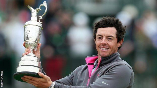 Rory McIlroy holds aloft the Claret Jug