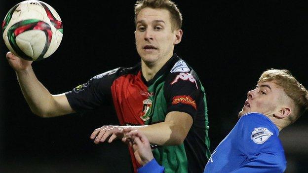 Johnny Addis of Glentoran in action against Glenavon's Mark Sykes