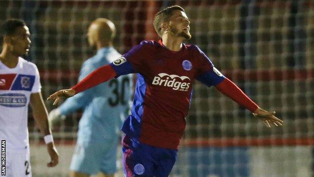 Adam McDonnell celebrates scoring a goal for Aldershot Town