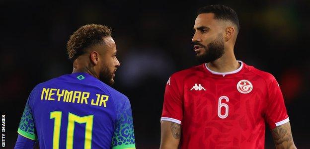 Neymar and Dylan Bronn in action during the friendly between Brazil and Tunisia