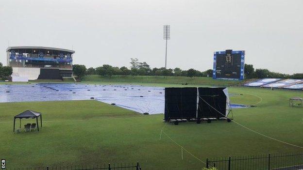 The covers on as rain falls at the MRIC Stadium in Hambantota, Sri Lanka on day two of England's warm-up match