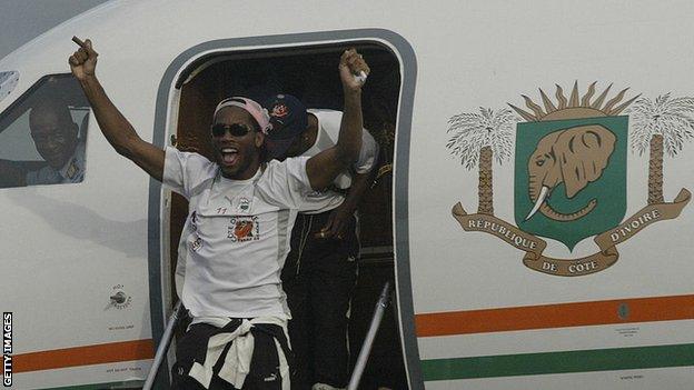 Didier Drogba emerges from the plane that took the victorious Ivory Coast team back home from Sudan