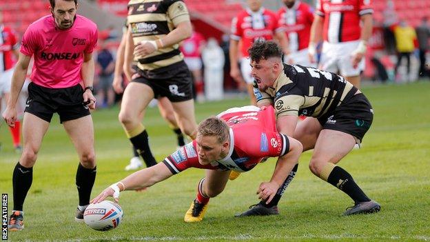 James Greenwood scores a try for Salford against Leigh