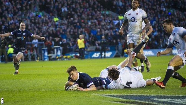 Scotland centre Huw Jones scores against England