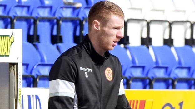 Stephen Pearson watches Saturday's match on crutches