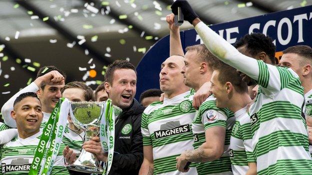 Celtic players celebrate with the Scottish League Cup