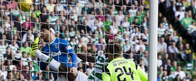 Rangers' Joe Garner heads in at Celtic Park