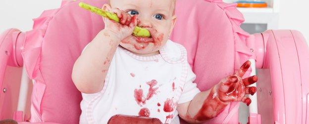 A baby in a high chair eating