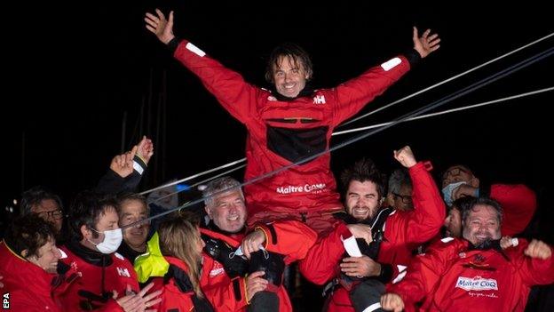 Yannick Bestaven is carried in triumph by his team members after winning the ninth Vendee Globe