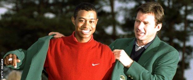 Nick Faldo helps 1997 Masters winner Tiger Woods of the USA put on the Green Jacket