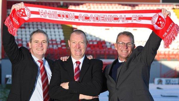 Hamilton chairman Allan Maitland, head coach Brian Rice and Hamilton director of football Allan McGonigal holding a scarf up