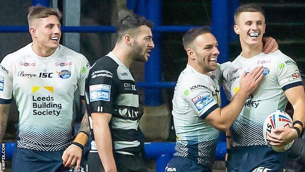 Leeds celebrate a try by Ash Handley