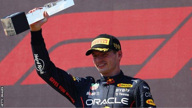 Max Verstappen lifts his trophy after winning the French Grand Prix