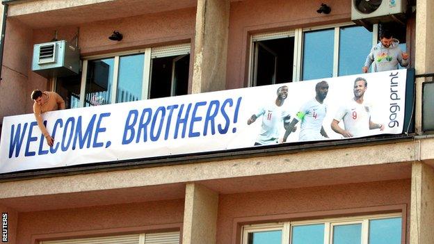 Banners of England players can be seen across Pristina