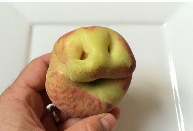 @uglyfruitandvegcampaign: peach with a smiling face.