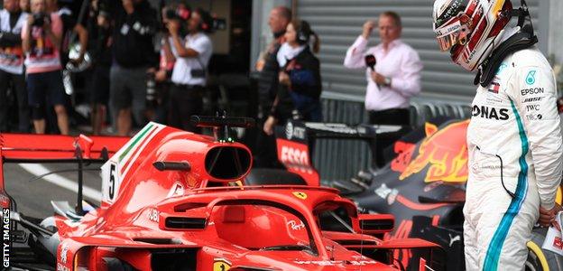 Lewis Hamilton looks on as Sebastian Vettel's Ferrari is in first place at Spa