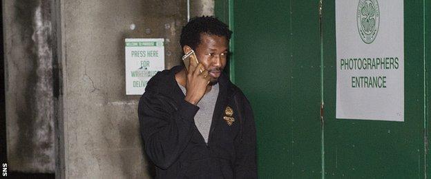 Efe Ambrose on the telephone outside Celtic Park