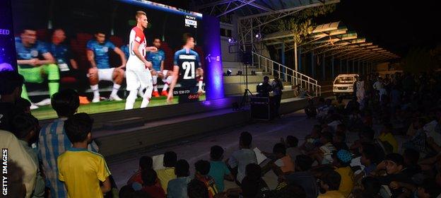 Fans in public areas in Lahore watch this summer's World Cup final