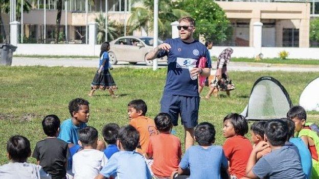 Lloyd Owers leads a football session for children in the Marshall Islands