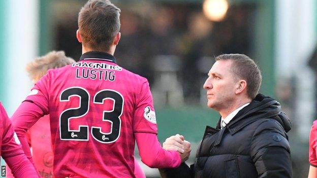 Celtic's Mikeal Lustig is congratulated by Brendan Rodgers