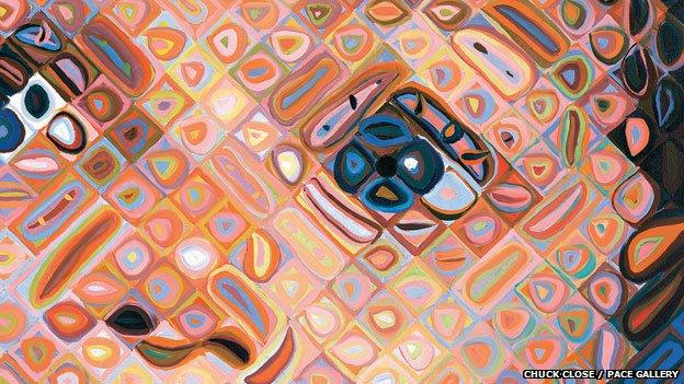 A close up of one of Chuck's paintings made up of lots of colourful diamonds that make up the face of a child