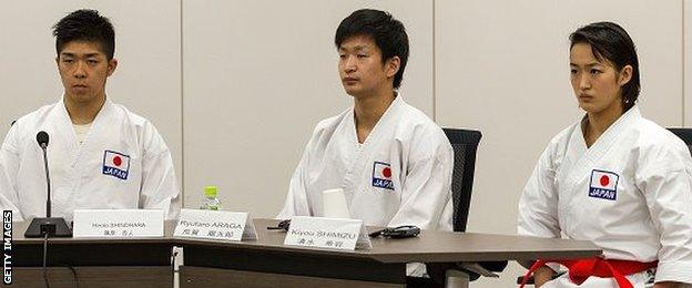 Athletes Hiroto Shinohara, Ryutaro Araga, and Kiyou Shimizu of the World Karate Federation (WKF) give a presentation