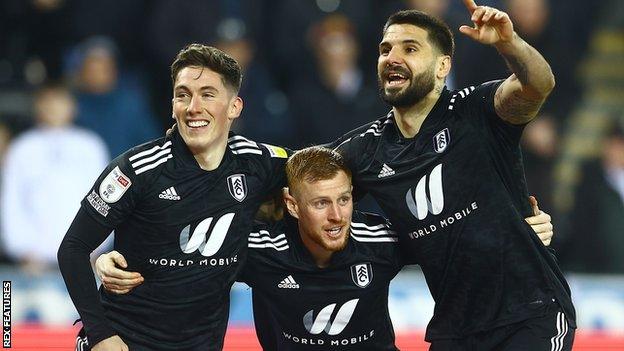 Fulham players celebrate a goal against Swansea