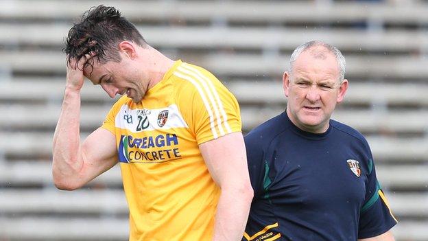 Antrim midfielder Niall McKeever with joint-manager Frank Fitzsimons