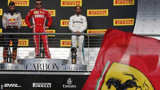 Ferrari's Finnish driver Kimi Raikkonen looks on as a Ferrari flag flies