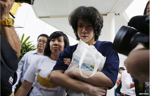 Teen blogger Amos Yee leaves with his parents after his sentencing, from the State Courts in Singapore 6 July 2015