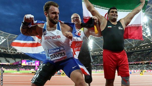 Aled Sion Davies celebrates his world shot put title with Frank Tinnemeier of Germany and Sajad Mohammadian of Iran