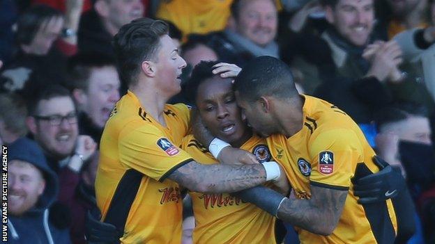 Newport County's players celebrate their winning goal against Leeds United in the third round of the FA Cup