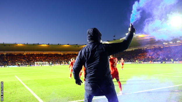 A fan took to the pitch with a blue flare to celebrate Callum Lang's 90th-minute winner at Home Park