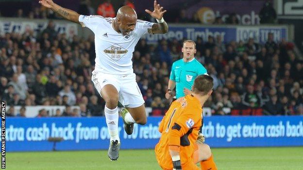 Swansea forward Andre Ayew took evasive action to avoid the challenge of Stoke's Jack Butland