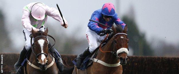 Paddy Brennan riding Cue Card clears the last to win The William Hill King George VI Steeple Chase from Vatour ridden by Ruby Walsh